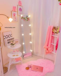 a room with pink rugs and lights on the walls