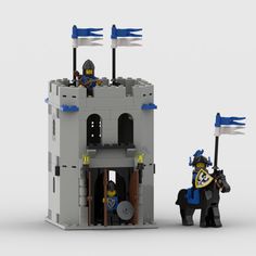 two lego knights standing in front of a castle with blue flags on their heads and one holding a flag