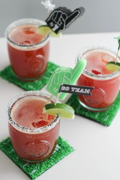 three cocktails with garnishes on the rim