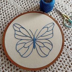 a close up of a embroidery on a piece of cloth with scissors next to it