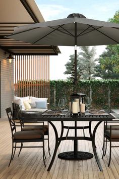 an outdoor table with chairs and an umbrella