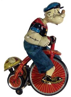 a figurine of a man riding a bike with a dog on the back