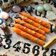 some carrots are on a table with numbers and other things around them including eggs