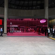 people are walking in front of a large advertisement