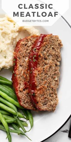 meatloaf on a plate with green beans and mashed potatoes