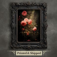 an ornate frame with pink roses in it on a gray wall next to a sign that says printed and shipped