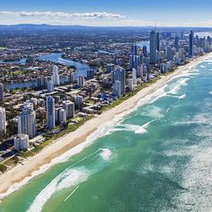 an aerial view of the gold coast with high rise buildings and blue water in the foreground