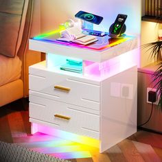 a white table topped with drawers and electronic devices