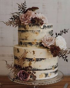 a three tiered cake with flowers on top