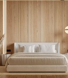 a large bed sitting in the middle of a bedroom next to a wall with wooden paneling