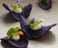 purple potato chips topped with green leaves and flowers