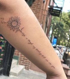 a woman's arm with a sunflower on it and the words, i love you