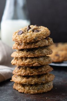 a stack of cookies sitting on top of a table next to a glass of milk