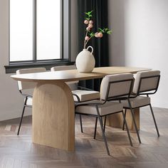 a dining room table with four chairs and a vase on the table in front of it