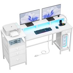 two computer monitors sitting on top of a white desk