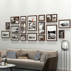 a living room filled with furniture and framed pictures on the wall above it's coffee table