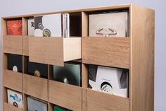 a wooden shelf with many different cd's in it