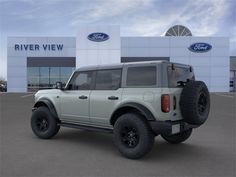 a white truck is parked in front of a ford dealership with the words river view on it