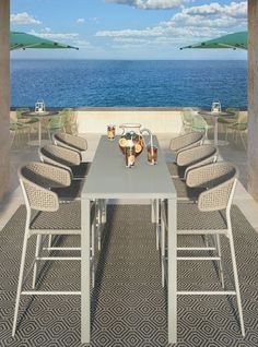 an outdoor dining area overlooking the ocean