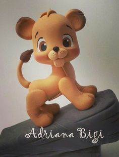 an adorable little lion figurine sitting on top of a rock with the caption adriana bigi