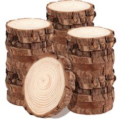 several logs stacked on top of each other in front of a white background and one log has been cut into smaller pieces