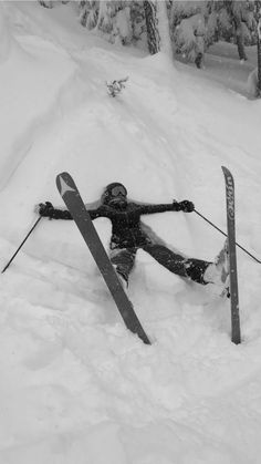 a person on skis laying in the snow