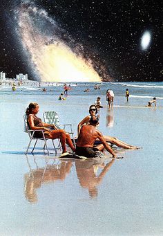 some people are sitting on the beach and one is looking at the stars in the sky