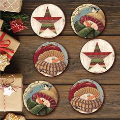 four plates decorated with turkeys and christmas decorations on a wooden table next to presents