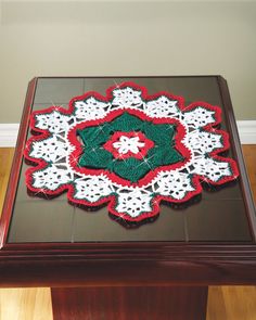 a crocheted doily on top of a wooden table