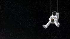 an astronaut floating in the air with his feet dangling from a string and holding a teddy bear