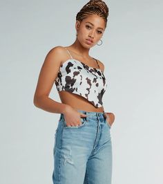 Channel your inner country chick in the cutest cow print satin crop top! The silky satin woven fabric showcases a trendy cow print pattern to bring that western vibe to your look. The top is shaped with a sleeveless cowl neckline and adjustable spaghetti straps to find your perfect fit. The smocked back design offers added stretch, and the V-shaped cropped hem will create a chic silhouette. Style with light-wash jeans and booties!Fit & FeaturesSatin woven fabric, cow print, sewn-in liningSle Trendy Satin Crop Top, Cow Print Top Outfit, Trendy Cow Print Tops For Spring, Trendy Cow Print Top For Summer, Cow Print Outfit, Printed Top Outfit, Crop Top Blanco, Cow Print Pattern, Backless Dress Short