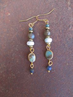 ♥Jewelry designs made by hand with heART♥ These linear and lightweight earrings are a cascade of beautiful gemstones of faceted Emerald, faceted Labradorite, Larimar rondelles, an oval disc of Turquoise wrapped in brass and faceted Lapis Lazuli with brass accent beads all combined together to complete your gemstone boho look. Lovely, lightweight linear earrings.  They measure a tad over 2 1/2 inches from the top of the pierced ear wires. The earrings pictured are the ones you will receive. Handm Gem Stone Earrings, Handmade Earthy Drop Earrings, Earthy Handmade Drop Earrings, Earthy Style Drop Earrings With Matching Set, Earthy Jewelry With Matching Earrings For Everyday, Earthy Dangle Jewelry For Everyday, Earthy Turquoise Dangle Jewelry, Earthy Everyday Dangle Jewelry, Earthy Turquoise Dangle Earrings