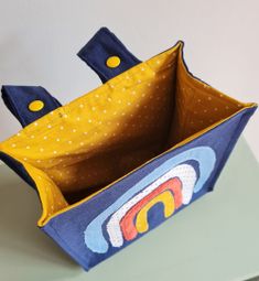 an origami box with handles made to look like a boat