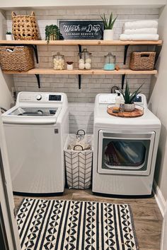 a washer and dryer sitting in a small room next to a shelf with baskets on it