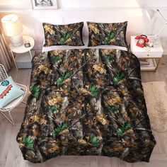 a bed covered in camouflage sheets and pillows