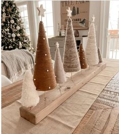 small christmas trees are lined up on a table