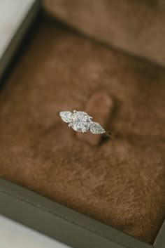 an engagement ring sitting in a box on top of a table