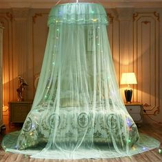 a canopy bed in a room with wooden floors