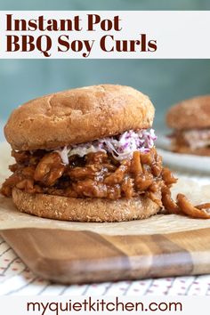 a bbq sandwich on a wooden cutting board with the words instant pot bbq soy curls