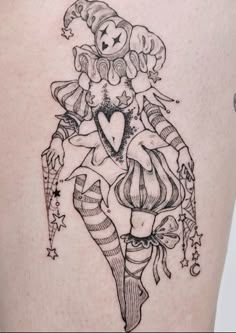 a woman with a heart tattoo on her thigh