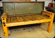 a bench made out of wooden pallets with the word international written on it, sitting in a garage