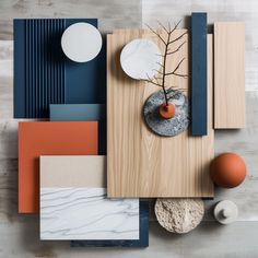 an assortment of different materials on top of a wooden table with orange and blue accents