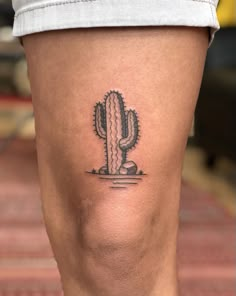 a small cactus tattoo on the leg