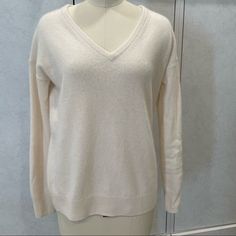 In Good Condition. Has A Small Mark On Sleeve. Not Very Noticeable See Attached Pictures. Ivory Color. 100% Cashmere. V Neck Neckline. Size Xs. Chest Measurement-20”. Ref-Ml 801923 Classic White Cashmere Top, White Cashmere Top For Spring, White Cashmere Tops For Spring, White Cashmere Tops For Layering, Elegant White V-neck Sweater, Elegant Cream Cashmere Top, White Cashmere Sweater For Layering, Spring Cream Cashmere Top, White Cashmere Winter Top