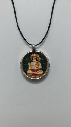 Handmade Glass Framed Covered by 92.5 Sterling Silver Hindu Powerful God Veer Hanuman ji Indian Miniature Painting Pendant With Colour String. Made by My Shop Member Pendant Langh With Loop 2.8 Cm. Pendant Width 2.6 Cm. Pendant Weight 3.6 GM's It's a Totally Handmade Glass Framed Necklace Covered By 92.5 Sterling Silver And Glass Used Natural Water Colours on Paper Sheet.... Artistic Silver Jewelry For Festivals, Hanuman Ji Locket, Indian Miniature, Hanuman Ji, Water Colours, Silver Locket, Art Pendant, Beautiful Gift Wrapping, Silver Lockets