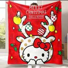 a hello kitty christmas blanket hanging on the wall in front of a child's room