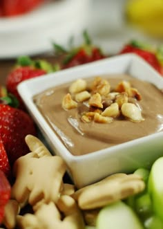 a bowl filled with chocolate pudding surrounded by fruit