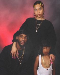 two women and a man posing for a photo