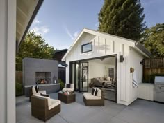 an outdoor living area with patio furniture and bbq