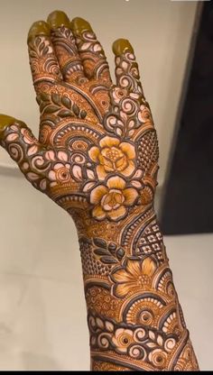 the hand is decorated with henna and flowers